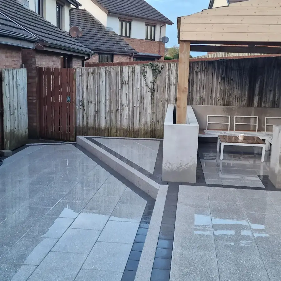 Large polished porcelain patio with pergola by Perfect Paving Belfast